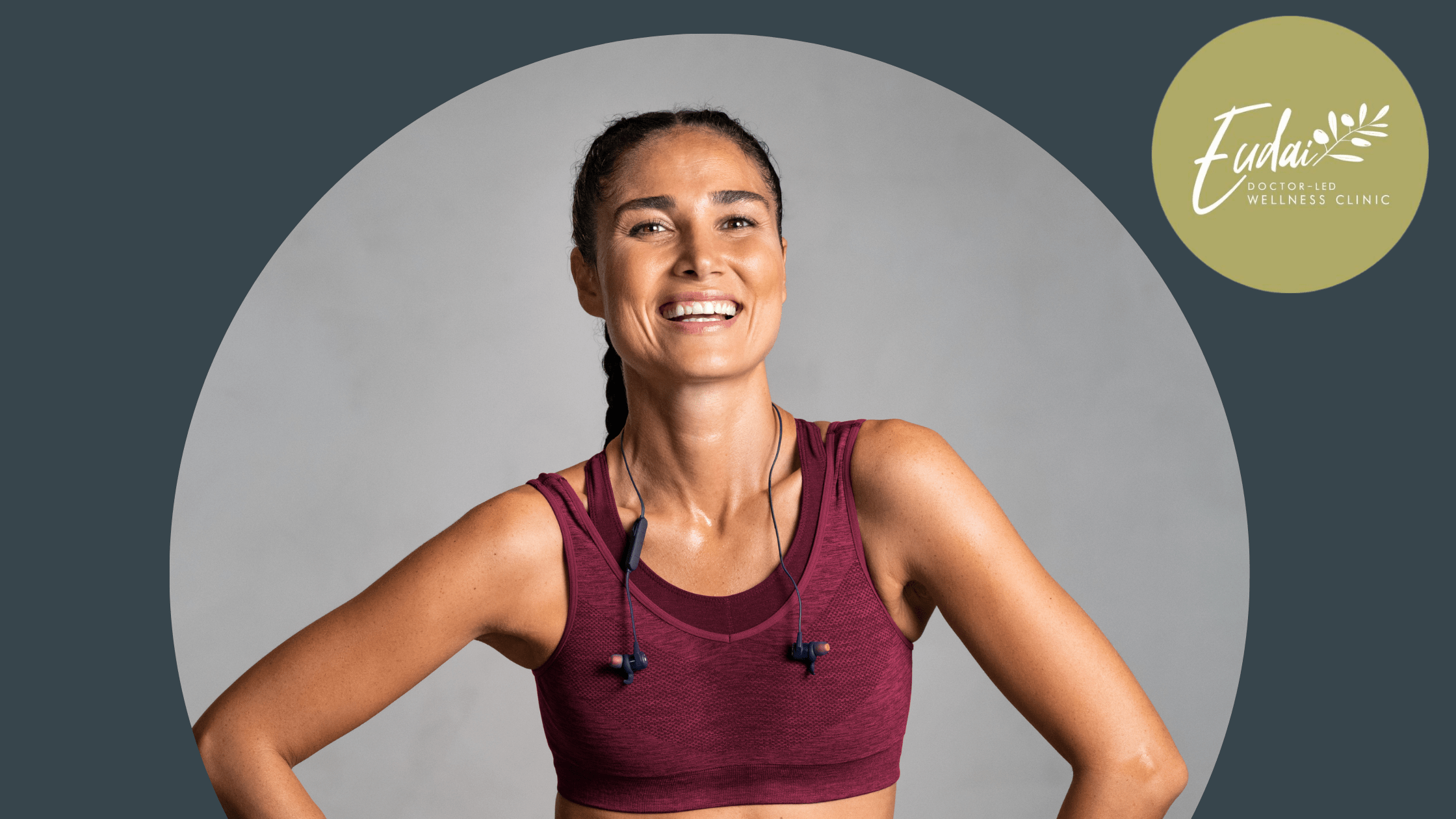 Eudai Clinic - woman with tan skin and braided hair wearing sportswear smiles into the camera