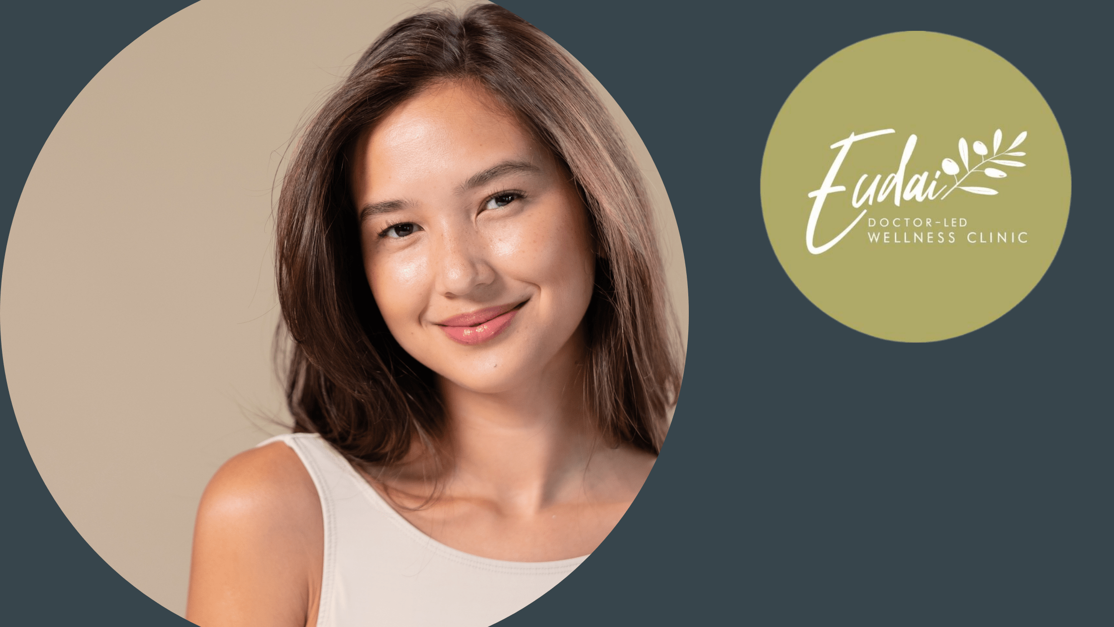 A young woman with long brown hair smiling softly while wearing a beige tank top. The Eudai Clinic logo is in the top left corner against a dark gray background.