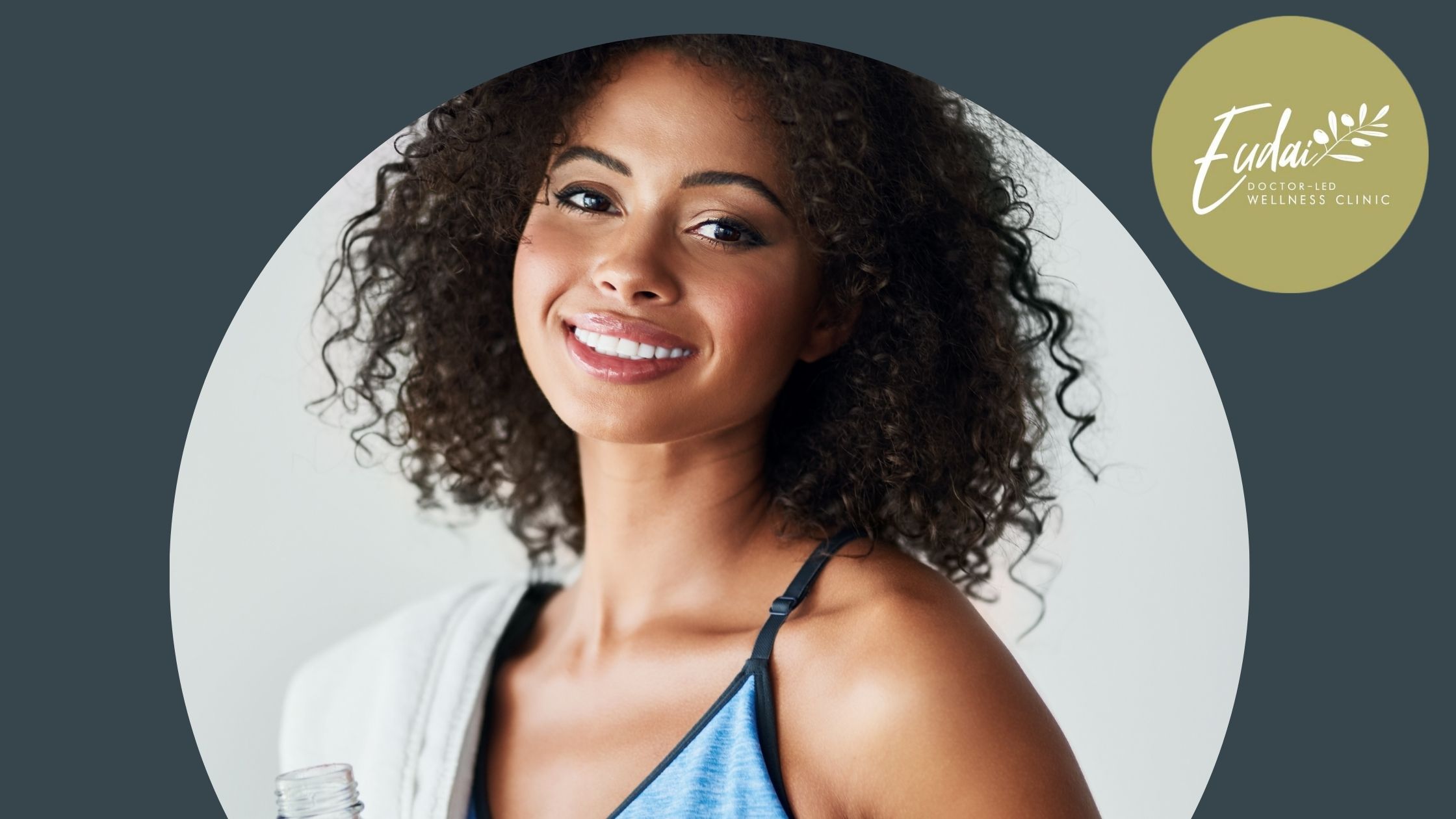 Eudai Clinic logo alongside a smiling woman with curly hair, wearing a sports top, holding a water bottle and a towel.